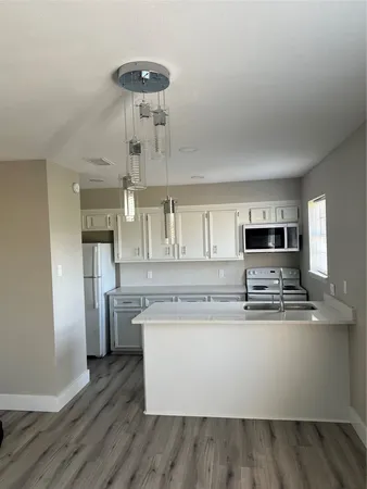 a kitchen with stainless steel appliances granite countertop a sink and refrigerator