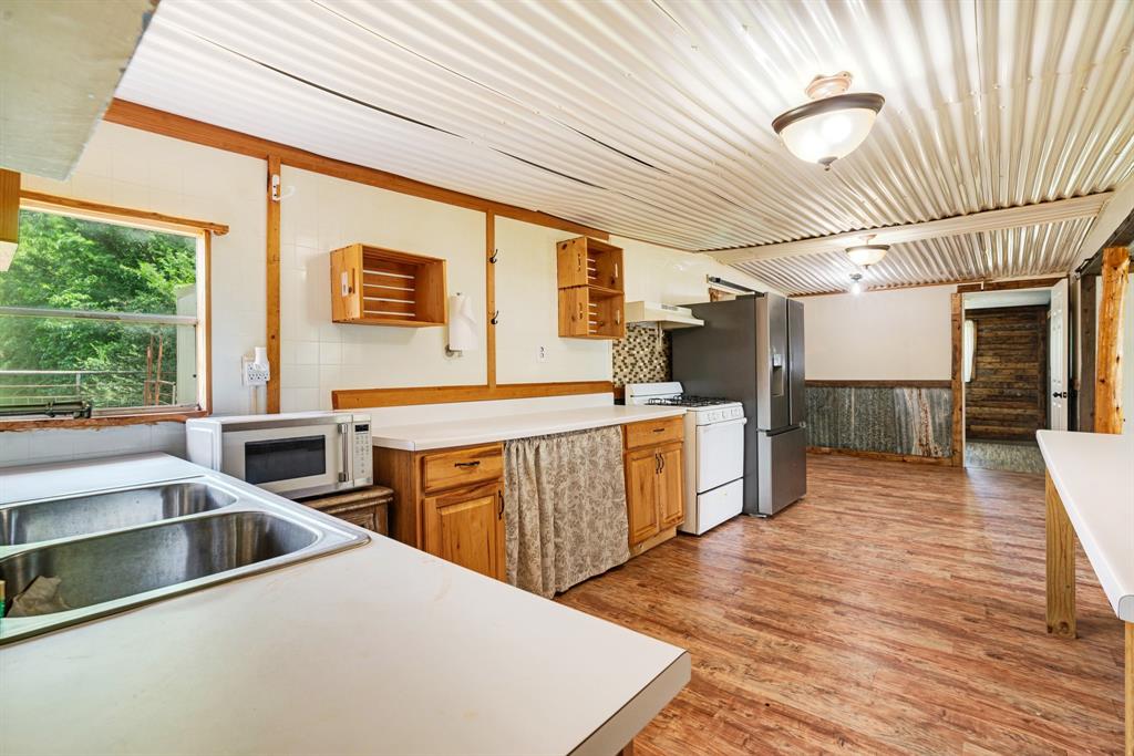 735 1st Southwest Detroit, TX 75436 - Photo 7 of 26 a kitchen that has a lot of cabinets in it