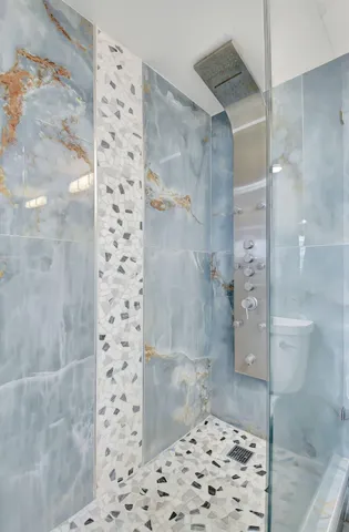 a bathroom with a toilet a sink and shower