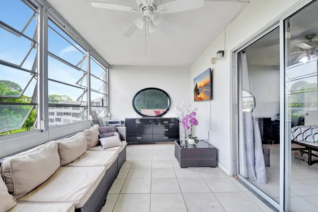 a living room with furniture and a floor to ceiling window