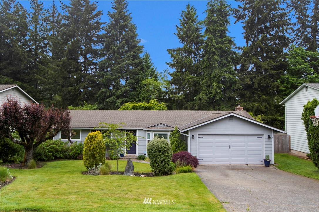 23625 48th Avenue Southeast Bothell, WA 98021 - Photo 1 of 40 a front view of a house with a yard and garage