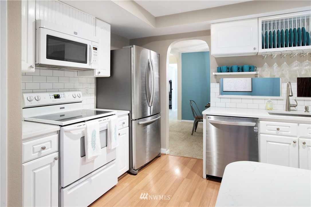 23625 48th Avenue Southeast Bothell, WA 98021 - Photo 14 of 40 a kitchen with stainless steel appliances a stove microwave and refrigerator