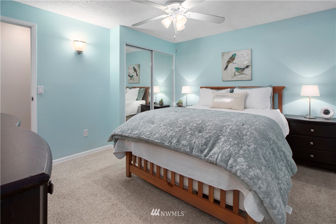 23625 48th Avenue Southeast Bothell, WA 98021 - Photo 20 of 40 a bedroom with a bed and a chandelier