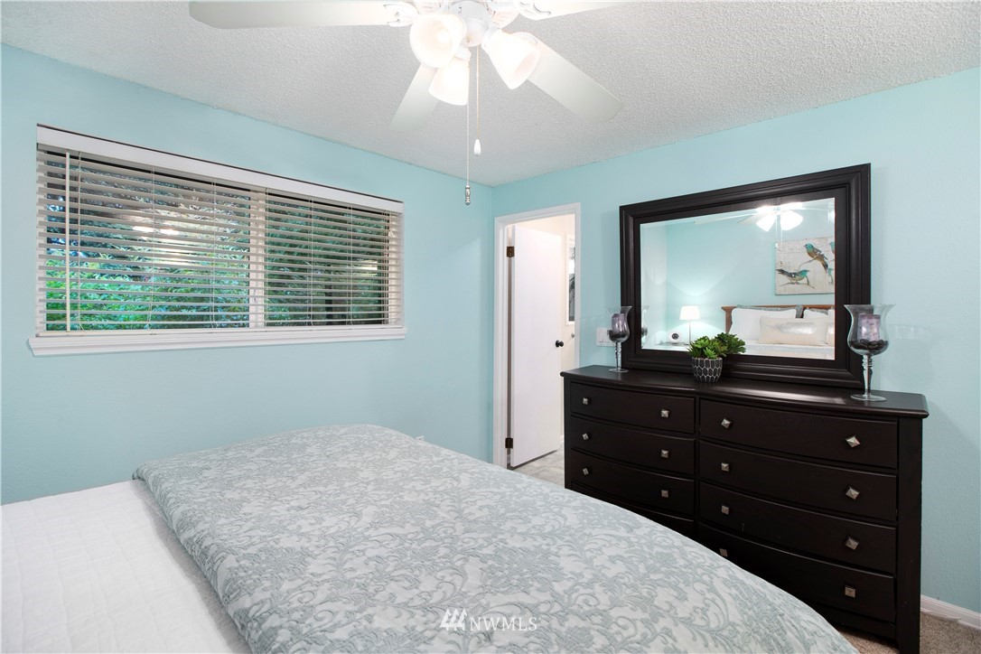 23625 48th Avenue Southeast Bothell, WA 98021 - Photo 21 of 40 a bedroom with a bed and a mirror on dresser