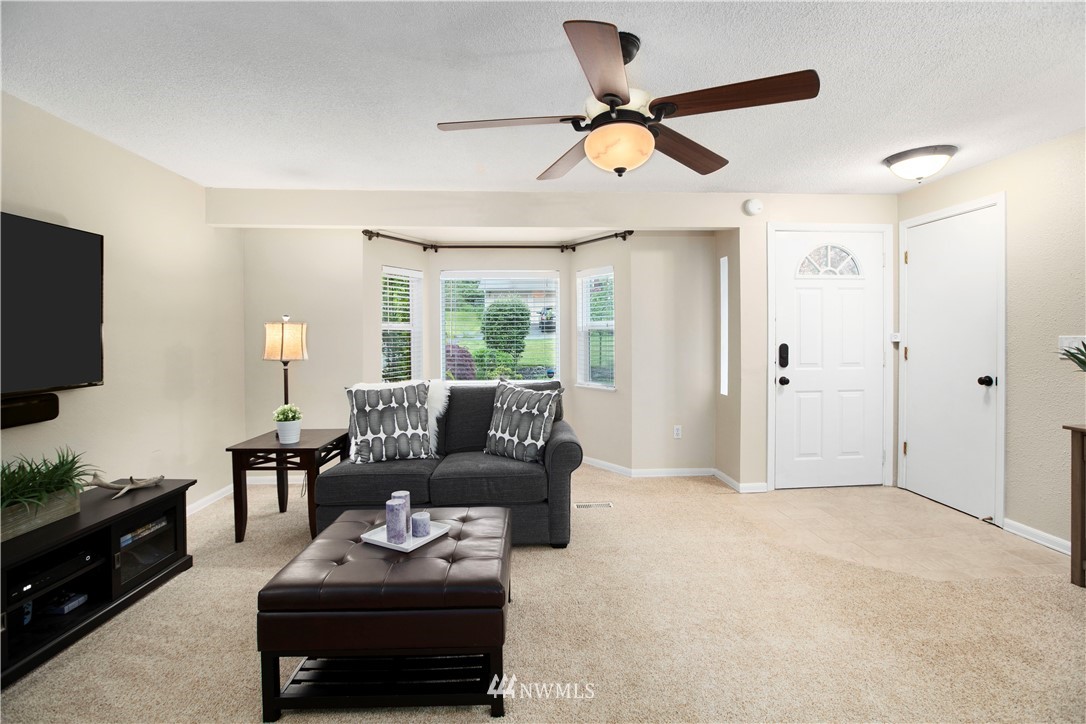23625 48th Avenue Southeast Bothell, WA 98021 - Photo 6 of 40 a living room with furniture and a flat screen tv