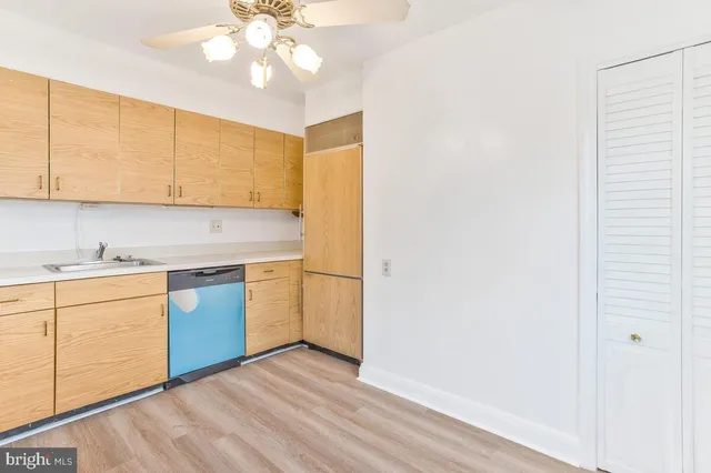 a kitchen with a sink cabinets and window