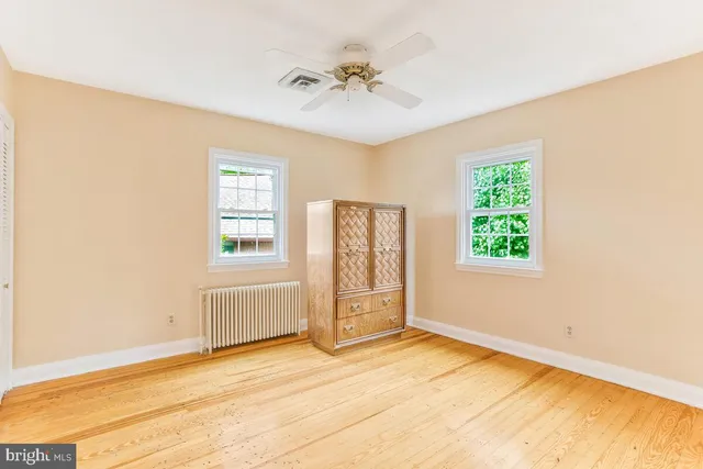 an empty room with windows and closet