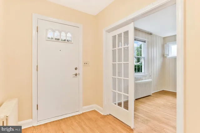 a view of a room with wooden floor and windows