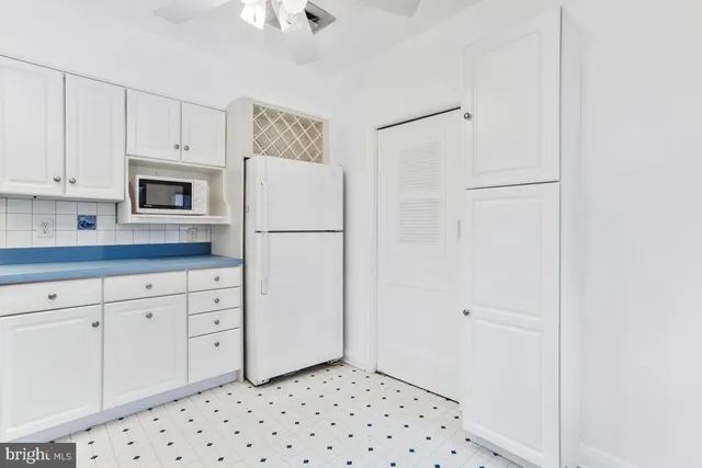 a white refrigerator freezer sitting inside of a kitchen