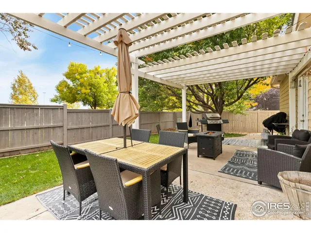 a living room with patio furniture and a garden