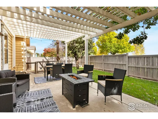 a view of a house with a backyard and a tree