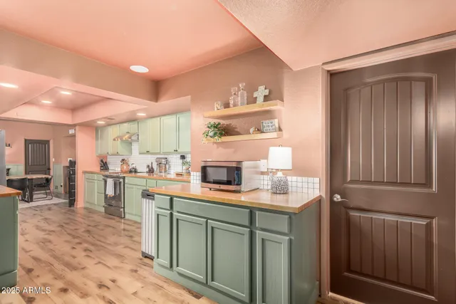 a kitchen with kitchen island granite countertop cabinets and window