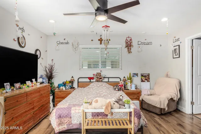 a bedroom with a bed and a flat screen tv