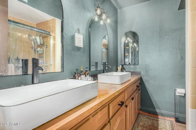 a bedroom with a bed and a painting on the wall