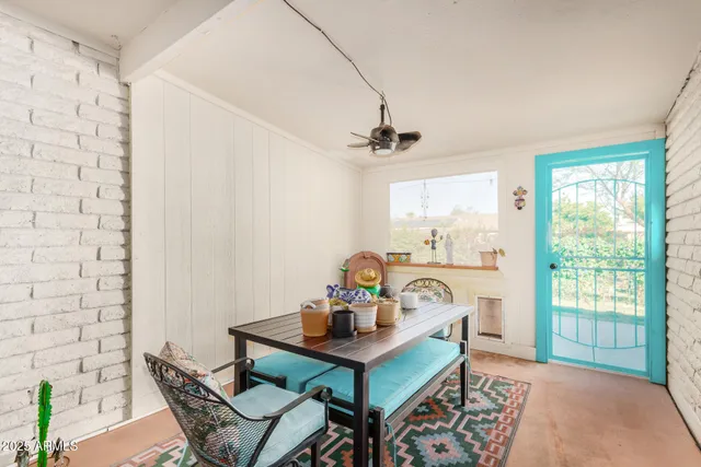a view of a deck with table and chairs and potted plants