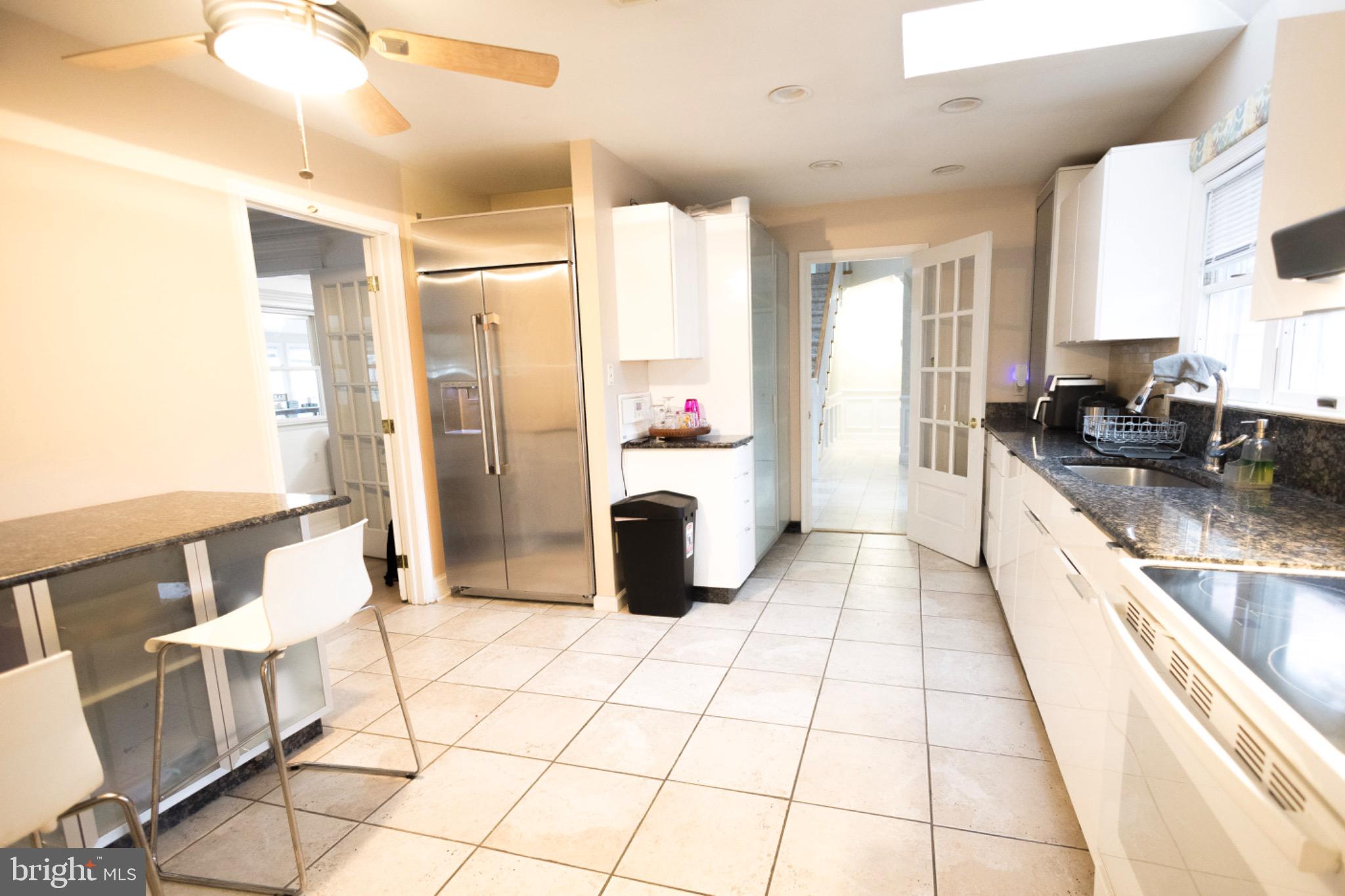 24 Rose Apple Road Levittown, PA 19056 - Photo 23 of 24 a kitchen with stainless steel appliances kitchen island granite countertop a refrigerator and a sink