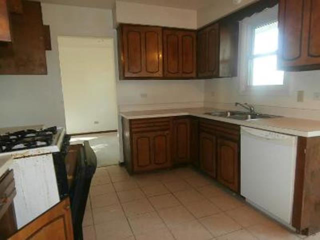 730 Cornfield Road Matteson, IL 60443 - Photo 7 of 12 a kitchen with a sink a stove and cabinets