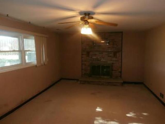 730 Cornfield Road Matteson, IL 60443 - Photo 9 of 12 en empty room with windows and fireplace