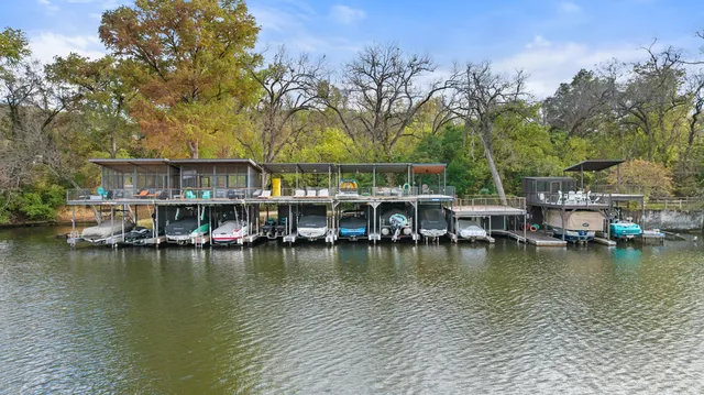 a view of a lake with boats and trees around