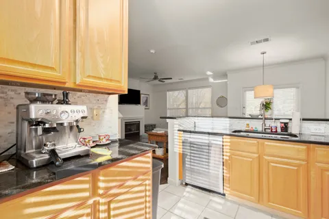 a kitchen with stainless steel appliances a sink and a large window