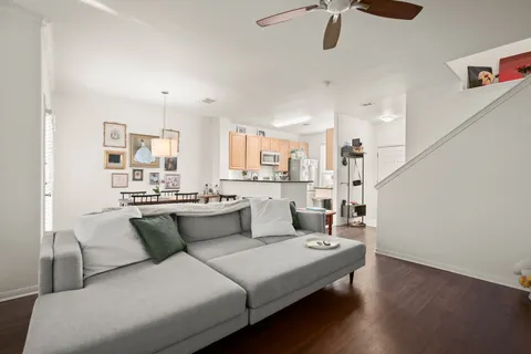 a view of backyard with wooden fence and a large tree