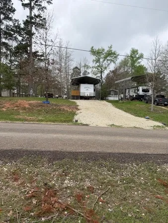 a yellow building with trees in the background