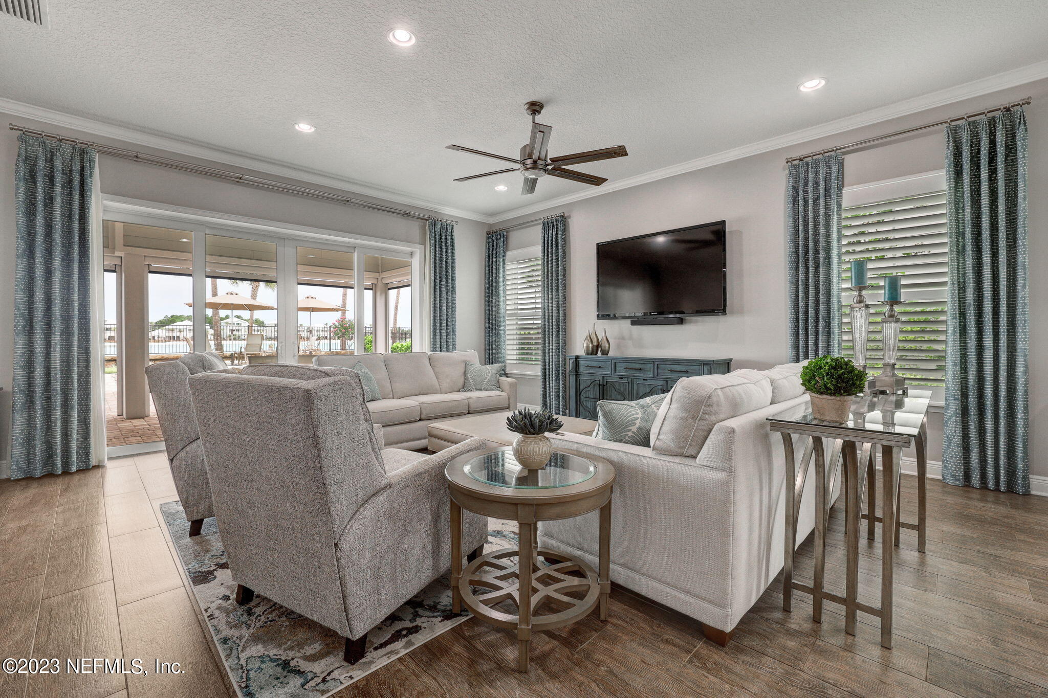 235 Rum Runner Way St. Johns, FL 32259 - Photo 16 of 108 a living room with furniture a flat screen tv and a large window