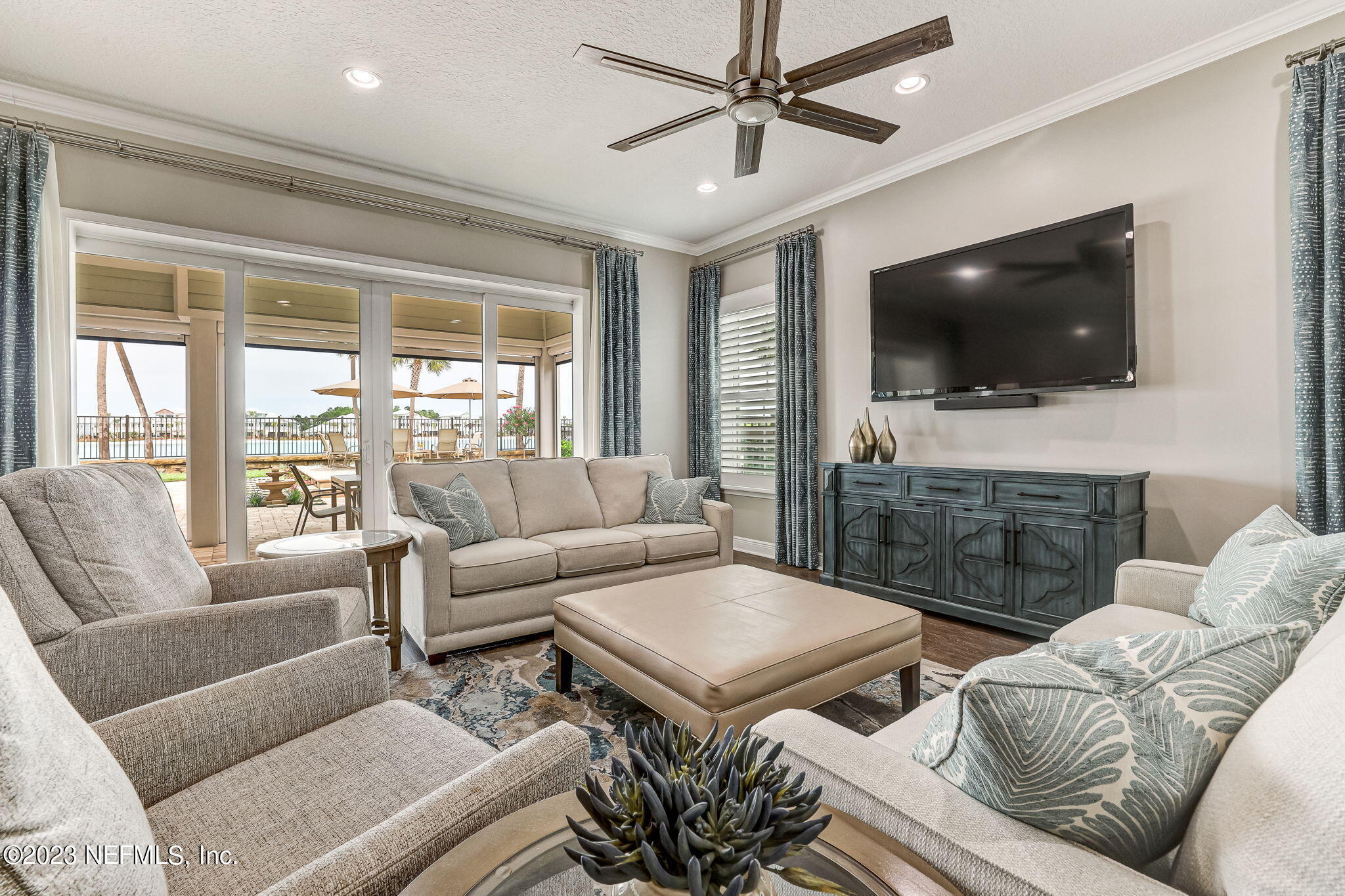 235 Rum Runner Way St. Johns, FL 32259 - Photo 18 of 108 a living room with furniture a flat screen tv and a large window