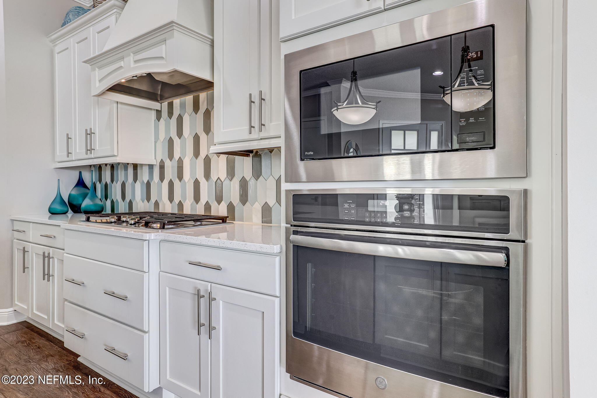 235 Rum Runner Way St. Johns, FL 32259 - Photo 29 of 108 a kitchen with stainless steel appliances granite countertop white cabinets and a granite counter tops