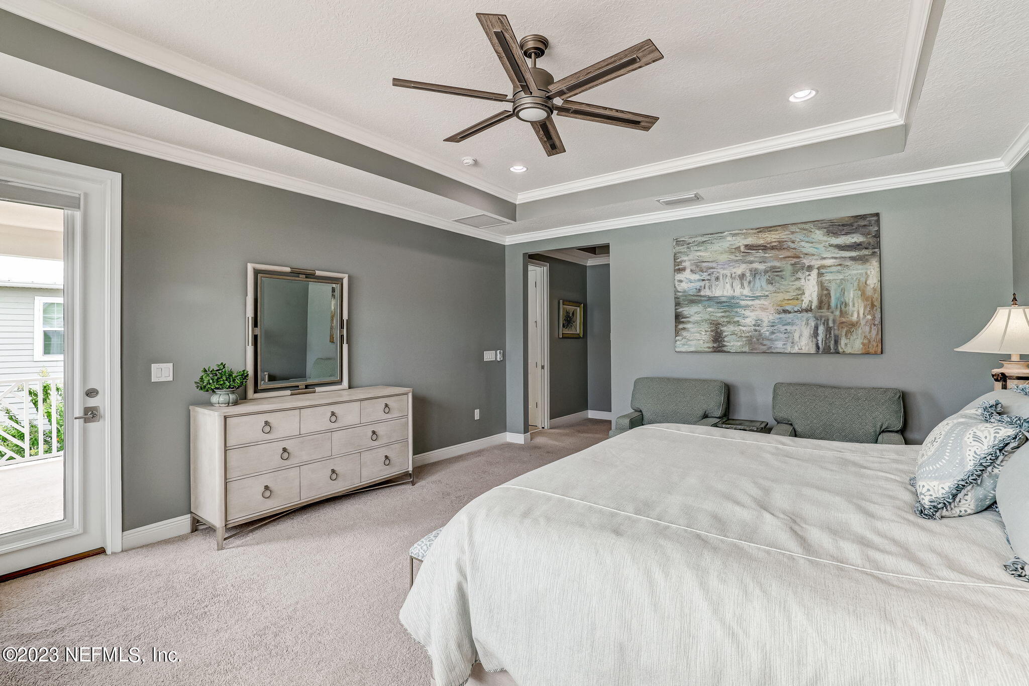 235 Rum Runner Way St. Johns, FL 32259 - Photo 45 of 108 a bedroom with a large bed and a chandelier fan