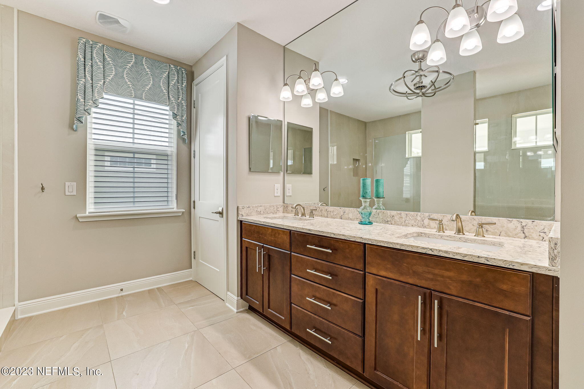 235 Rum Runner Way St. Johns, FL 32259 - Photo 49 of 108 a spacious bathroom with a granite countertop sink a large mirror and a shower