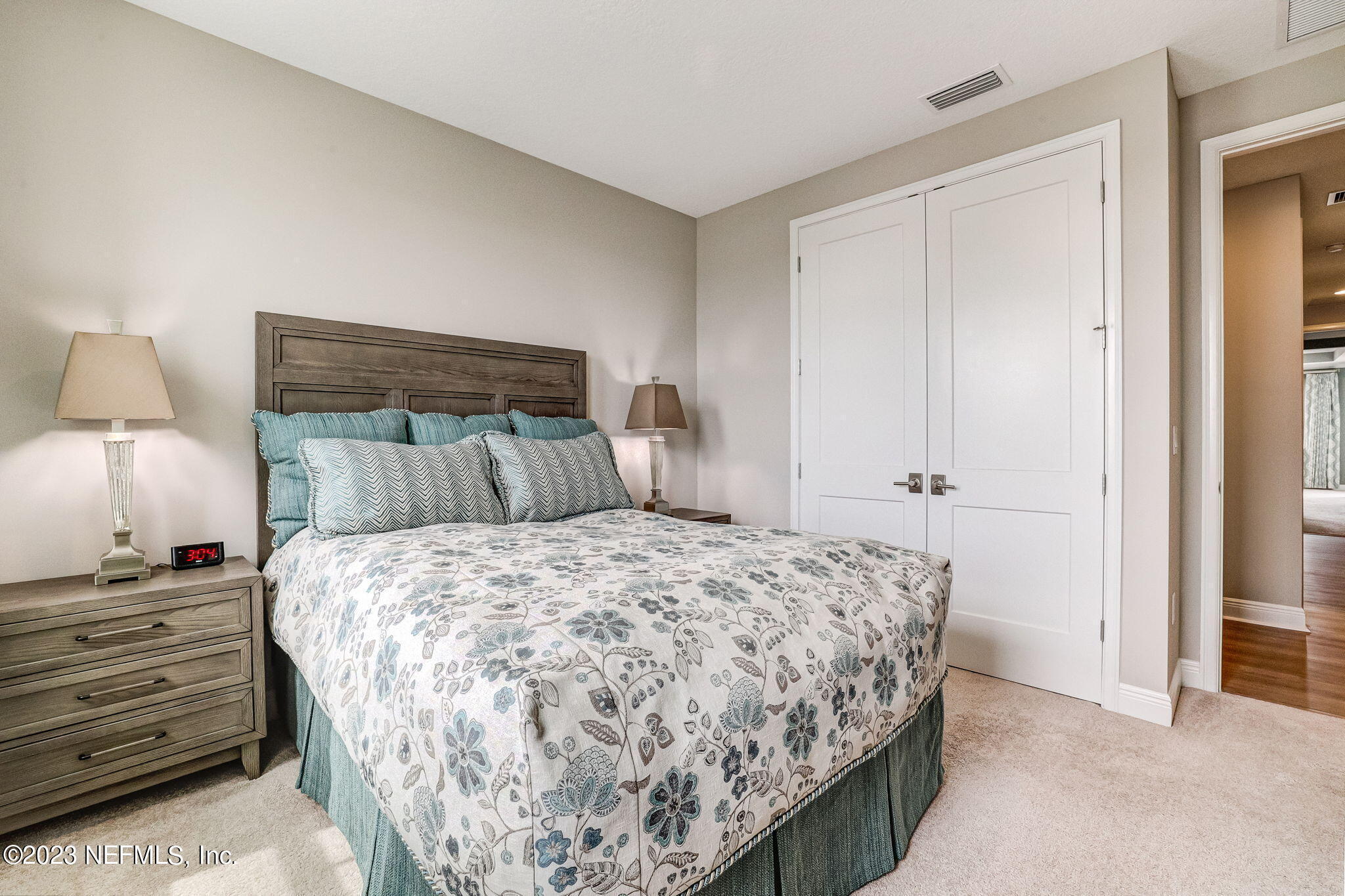 235 Rum Runner Way St. Johns, FL 32259 - Photo 54 of 108 a bedroom with a bed and a night stand