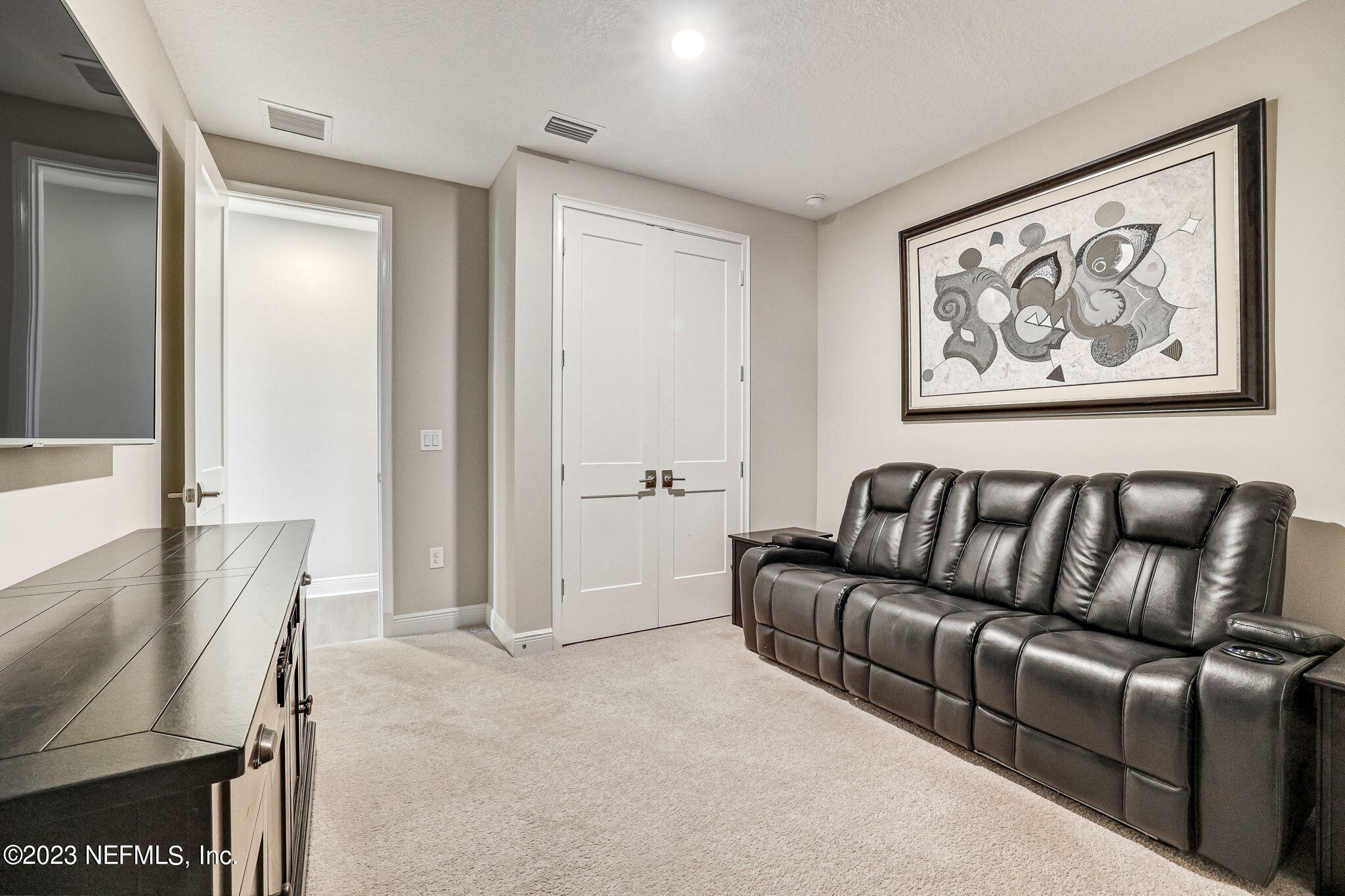 235 Rum Runner Way St. Johns, FL 32259 - Photo 60 of 108 a living room with furniture and a refrigerator