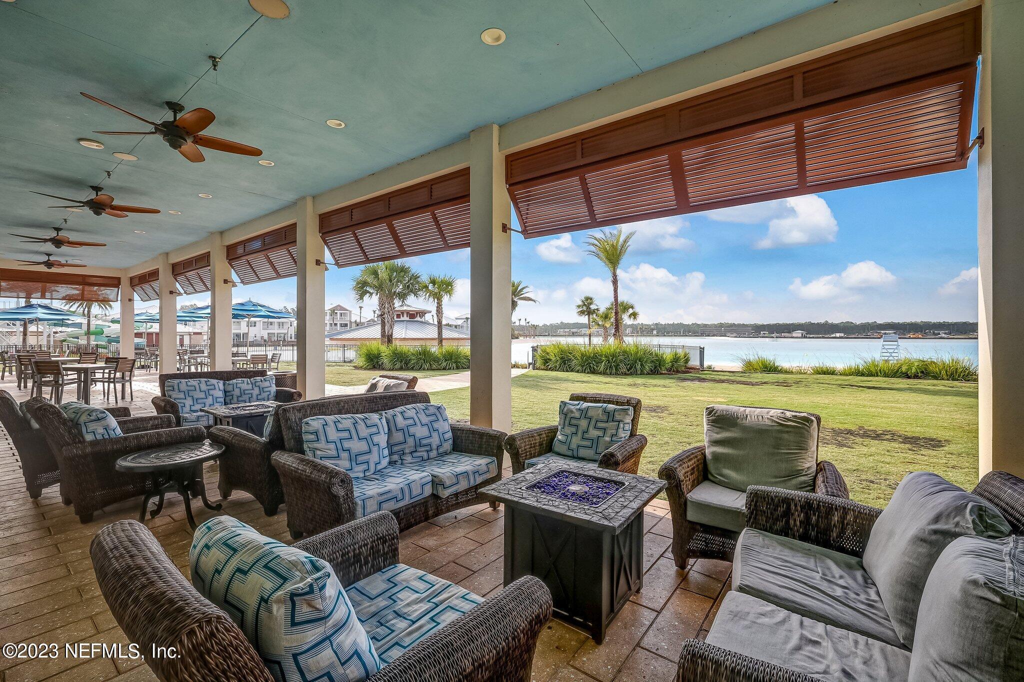 235 Rum Runner Way St. Johns, FL 32259 - Photo 73 of 108 a living room with furniture and a floor to ceiling window