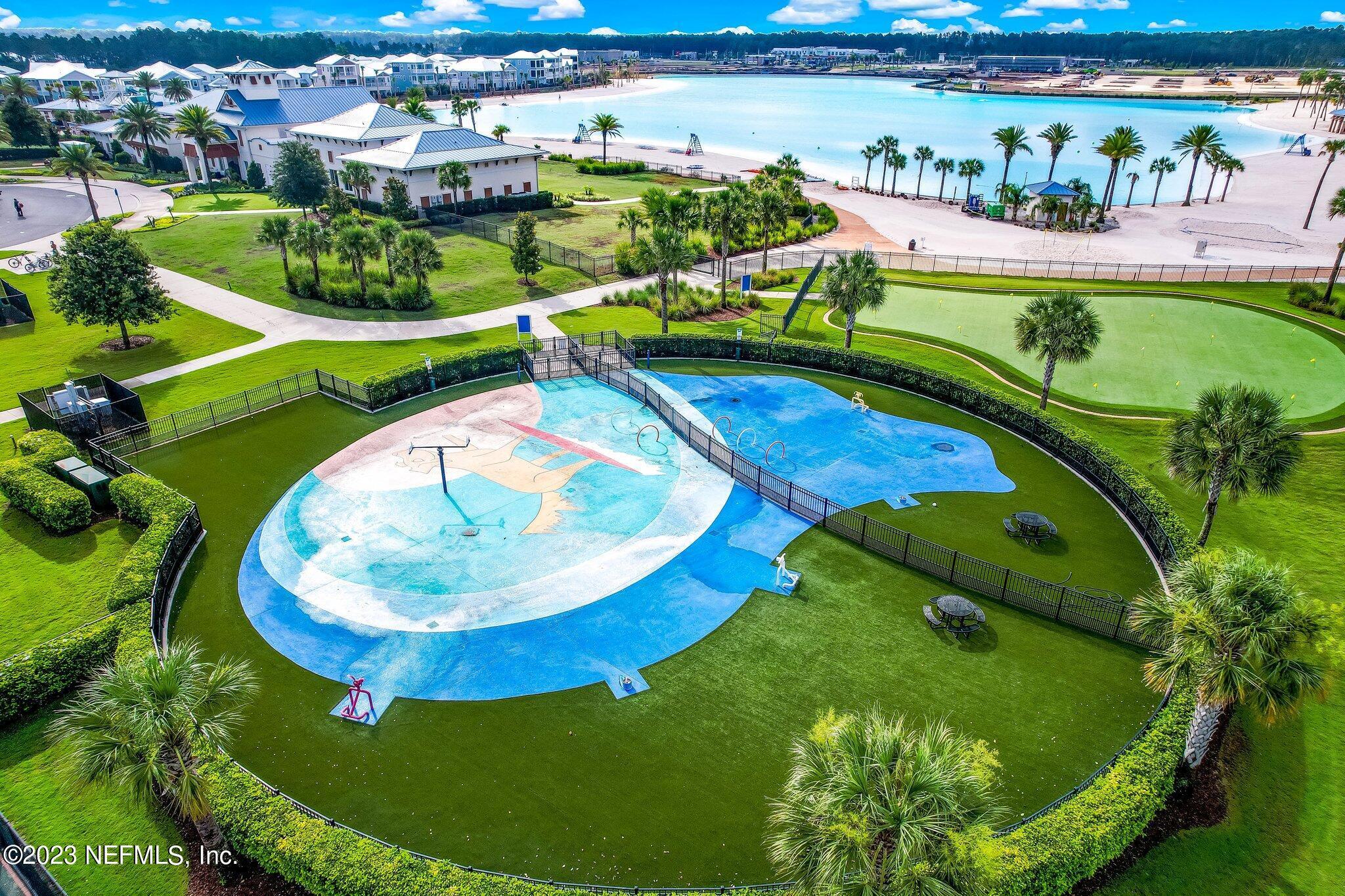 235 Rum Runner Way St. Johns, FL 32259 - Photo 98 of 108 a view of a swimming pool with a garden and plants