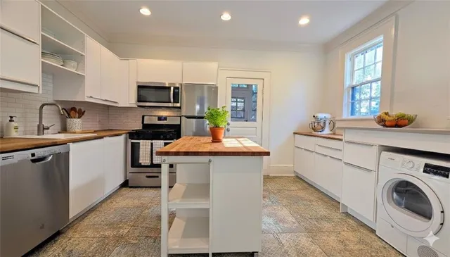 a kitchen with a sink cabinets and window