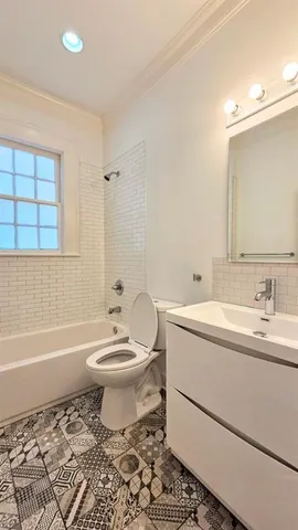a bathroom with a toilet a sink and bathtub