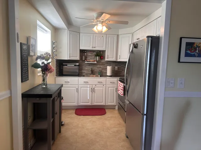 a kitchen with stainless steel appliances a refrigerator stove and sink