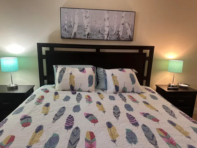 a bedroom with a bed and a lamp