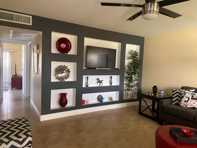 a view of a livingroom with furniture and a flat screen tv