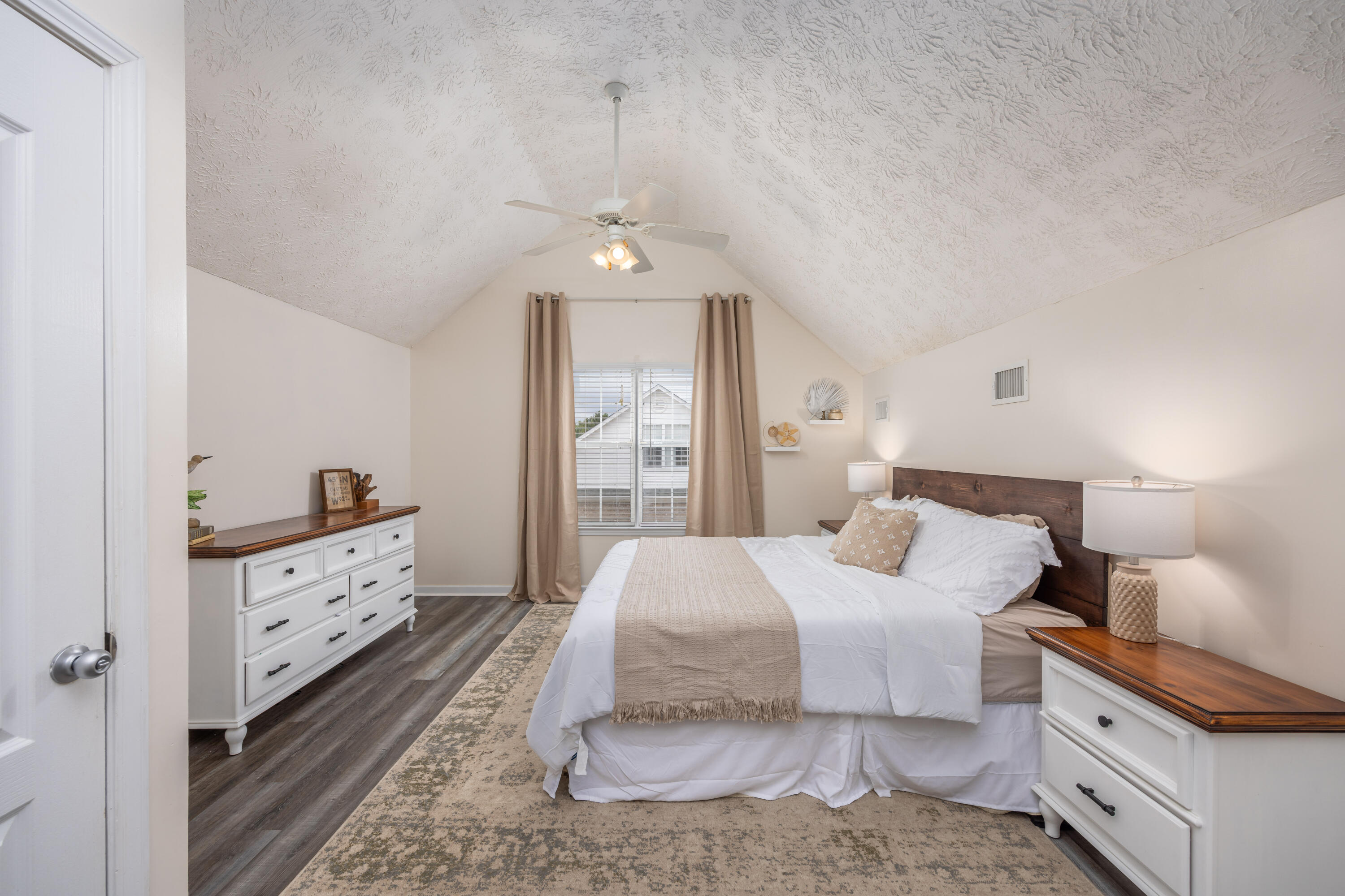 75 Mallot Beach Drive Freeport, FL 32439 - Photo 12 of 25 a spacious bedroom with a bed and a chandelier