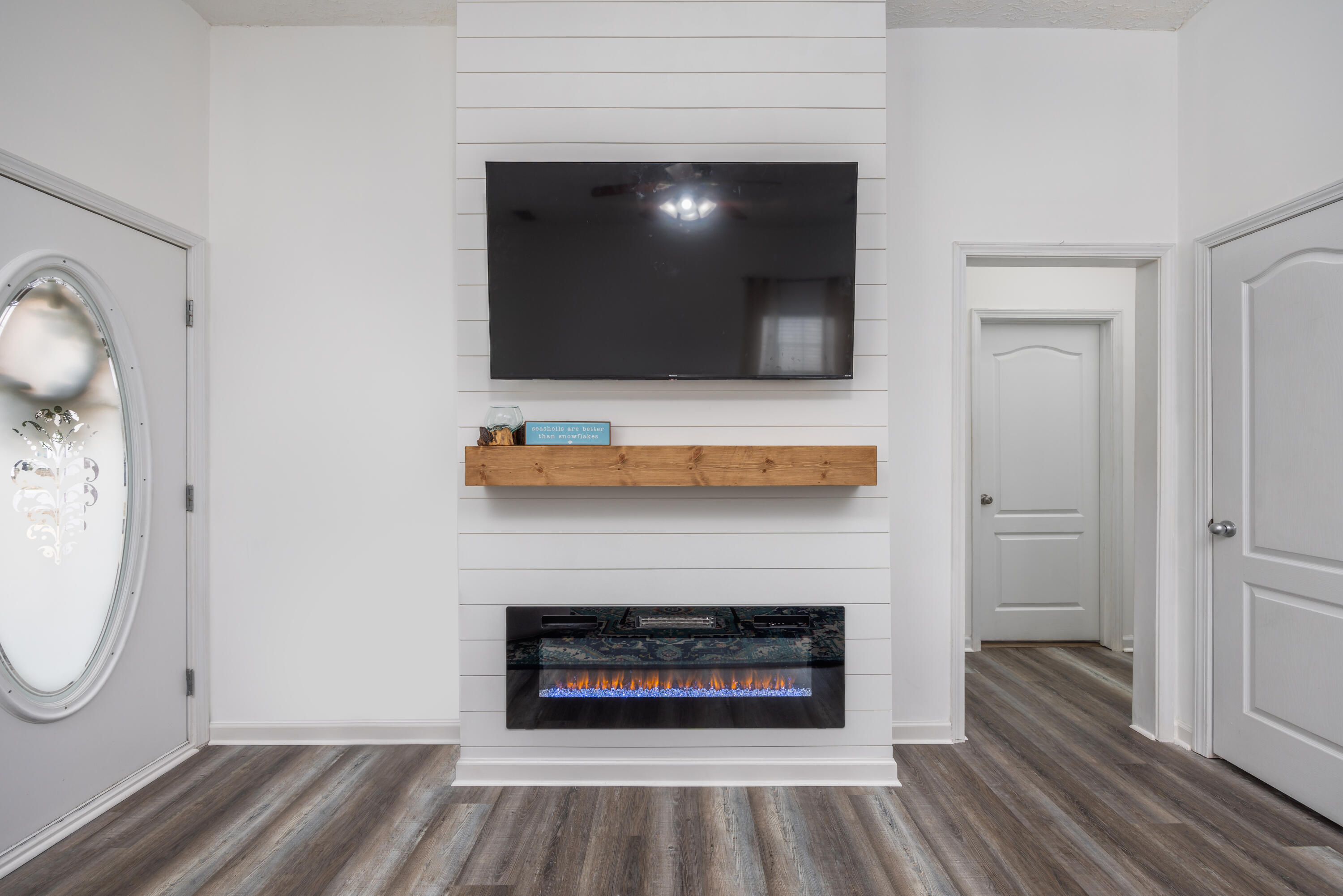 75 Mallot Beach Drive Freeport, FL 32439 - Photo 4 of 25 a living room with a fireplace a flat screen tv and a fireplace