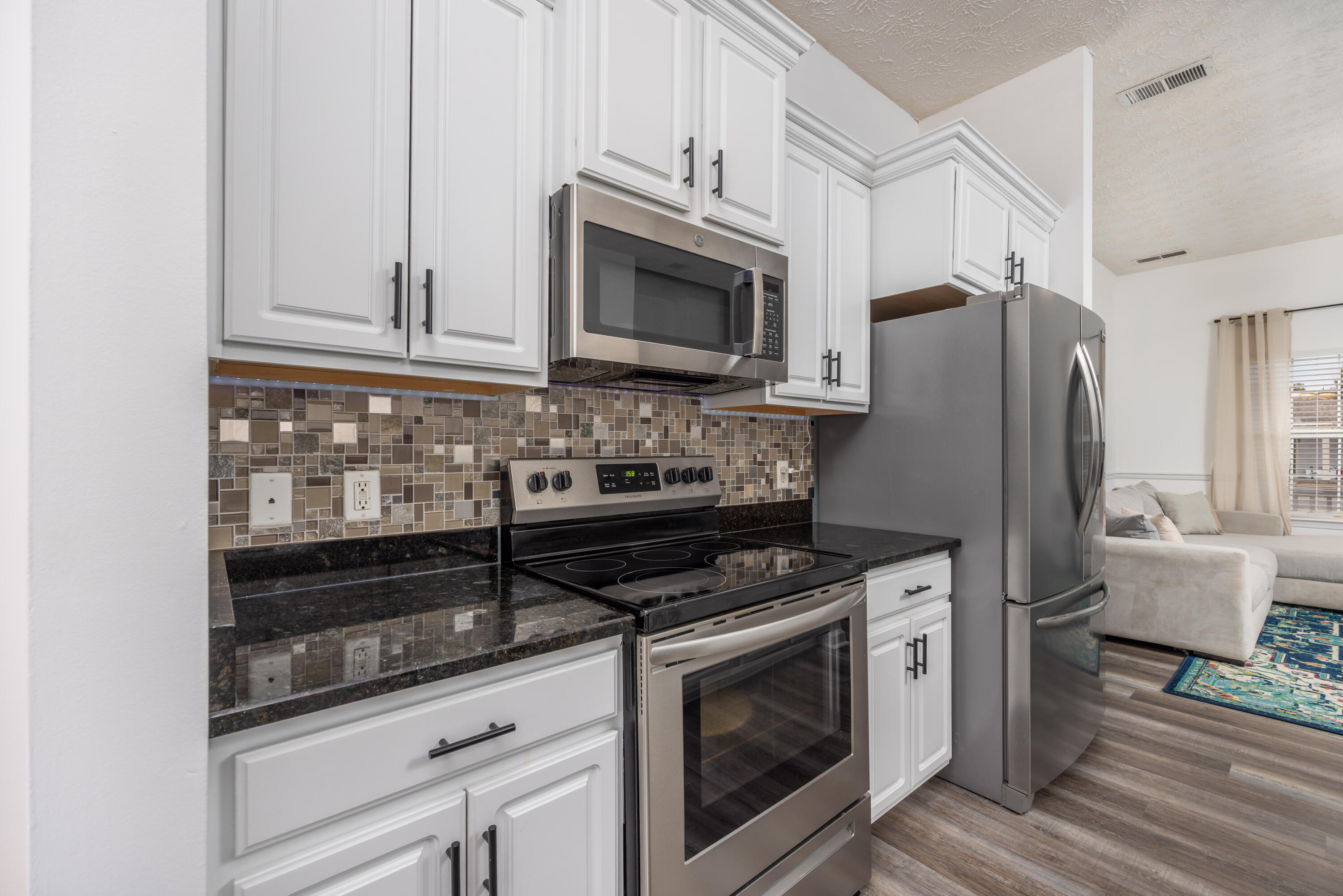 75 Mallot Beach Drive Freeport, FL 32439 - Photo 6 of 25 a kitchen with stainless steel appliances a stove a microwave and a refrigerator