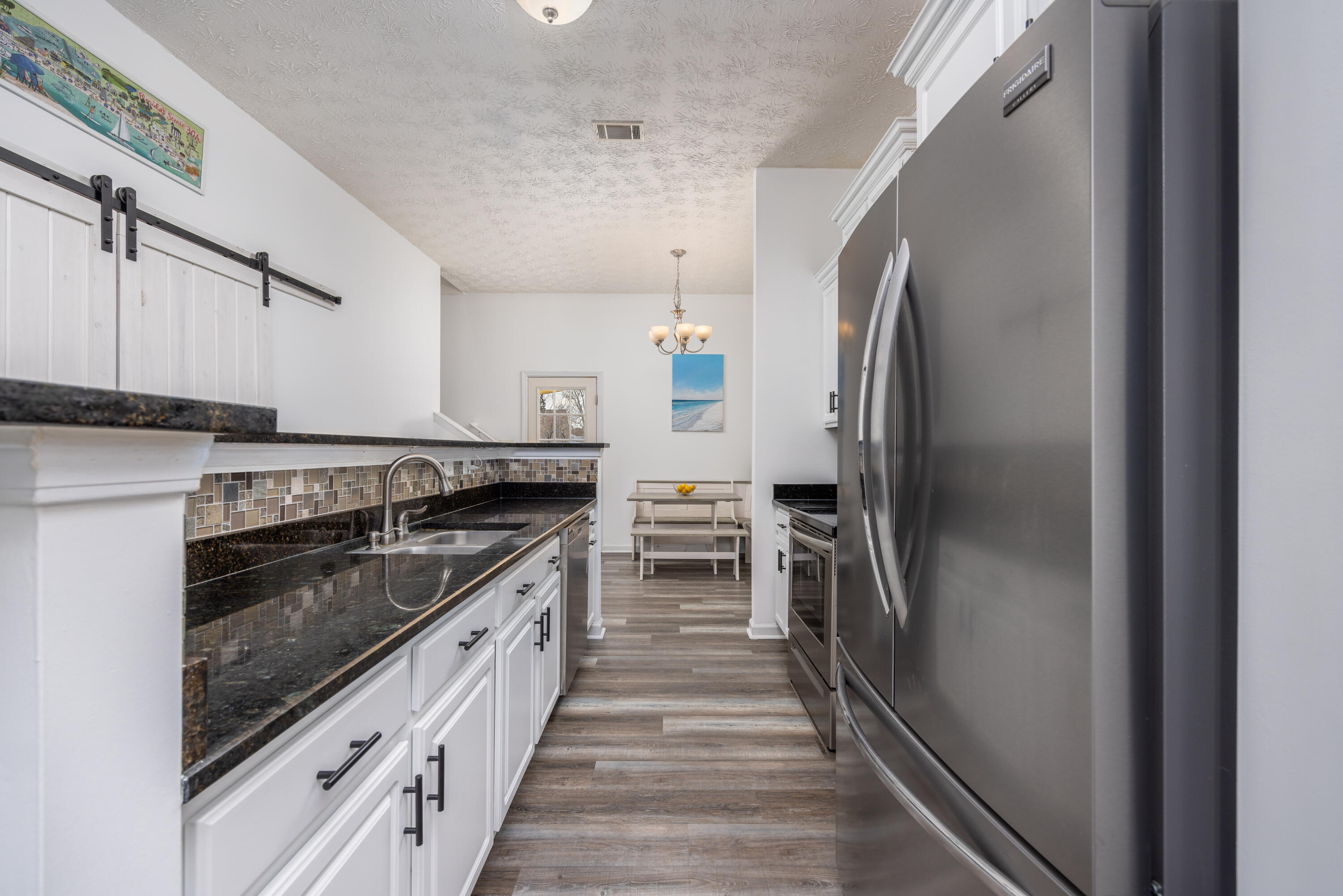 75 Mallot Beach Drive Freeport, FL 32439 - Photo 7 of 25 a kitchen with granite countertop a refrigerator and a sink