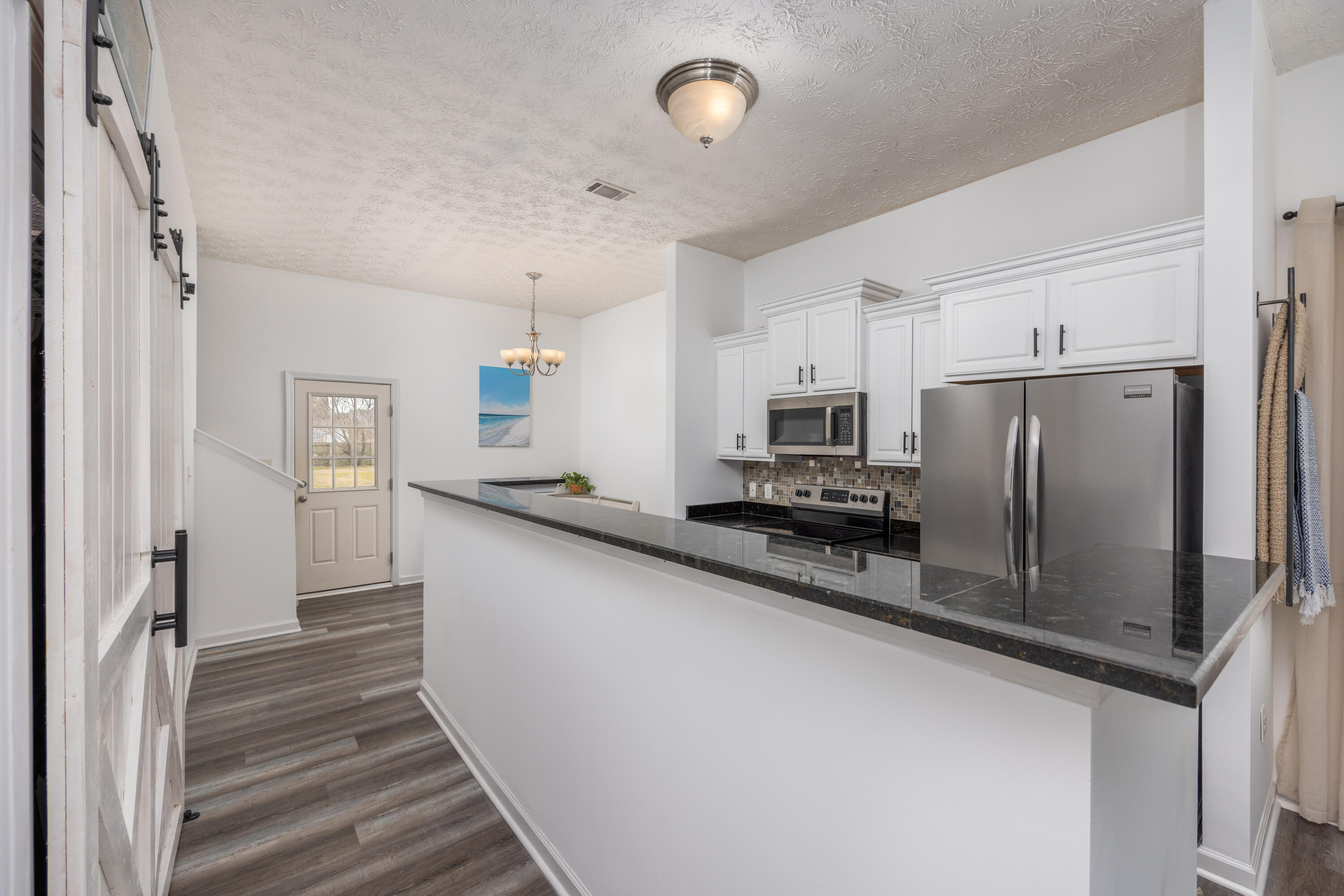 75 Mallot Beach Drive Freeport, FL 32439 - Photo 8 of 25 a kitchen with stainless steel appliances a refrigerator and microwave