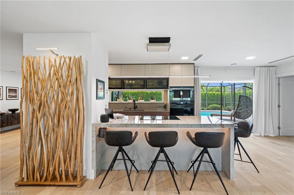 304 Nason Lane Naples, FL 34112 - Photo 1 of 43 a kitchen with a table chairs and a refrigerator