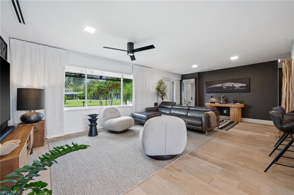 304 Nason Lane Naples, FL 34112 - Photo 14 of 43 a living room with furniture and a flat screen tv