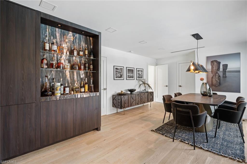 304 Nason Lane Naples, FL 34112 - Photo 17 of 43 a view of a dining room with furniture window and wooden floor