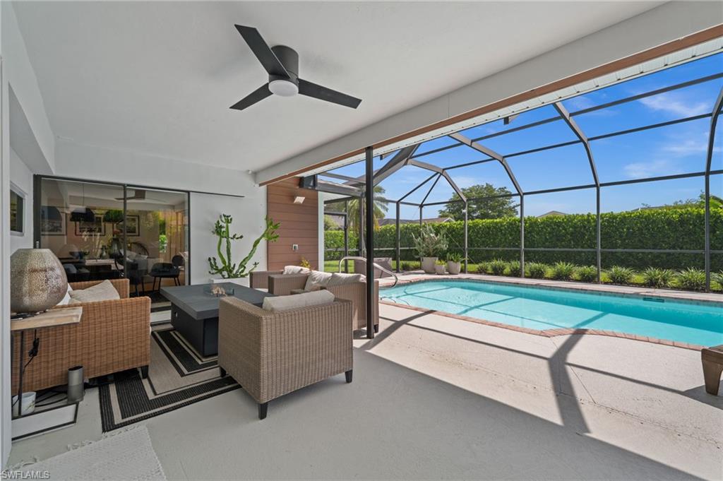 304 Nason Lane Naples, FL 34112 - Photo 2 of 43 a living room with couch a table and a large window
