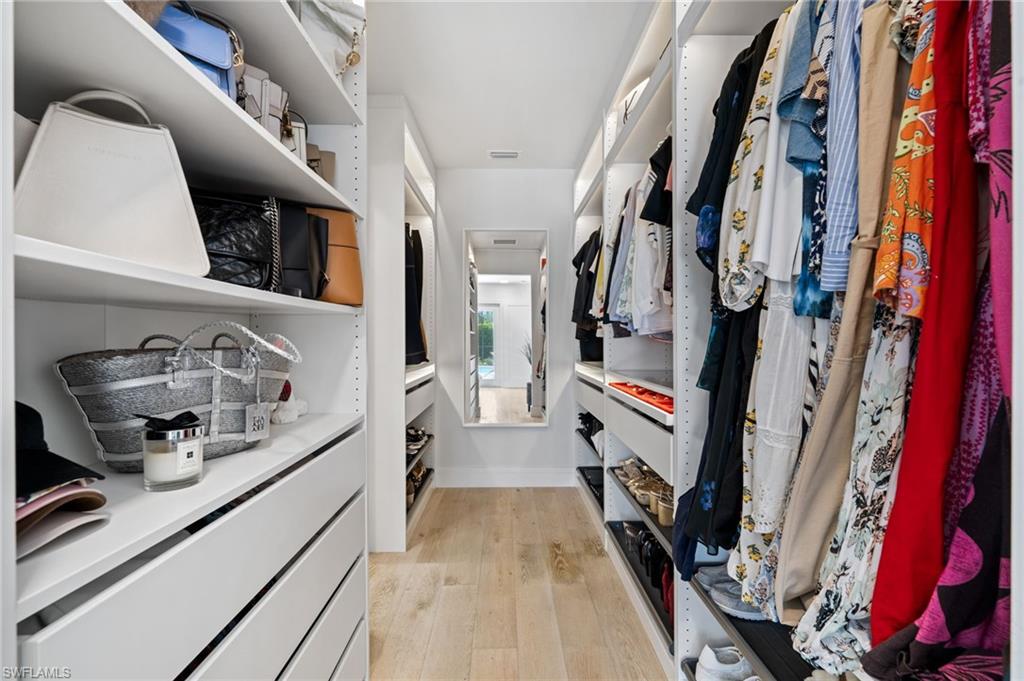 304 Nason Lane Naples, FL 34112 - Photo 21 of 43 a view of walk in closet with clothes and shoes